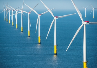 sunny view of a row of wind turbines
