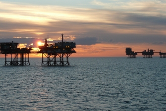 sunset, view onto working stations built on the seabed
