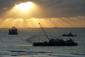sunset, you get a view of three boats laying cable on the seabed